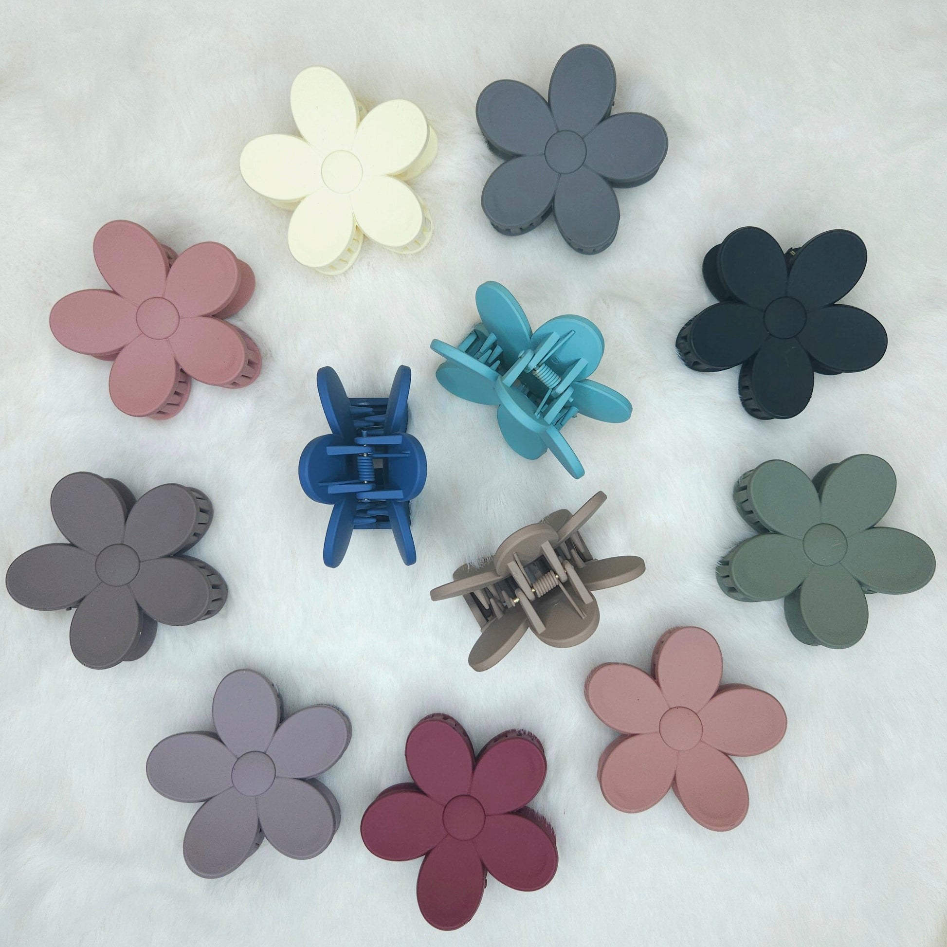 Colorful flower-shaped hair clips on a white background