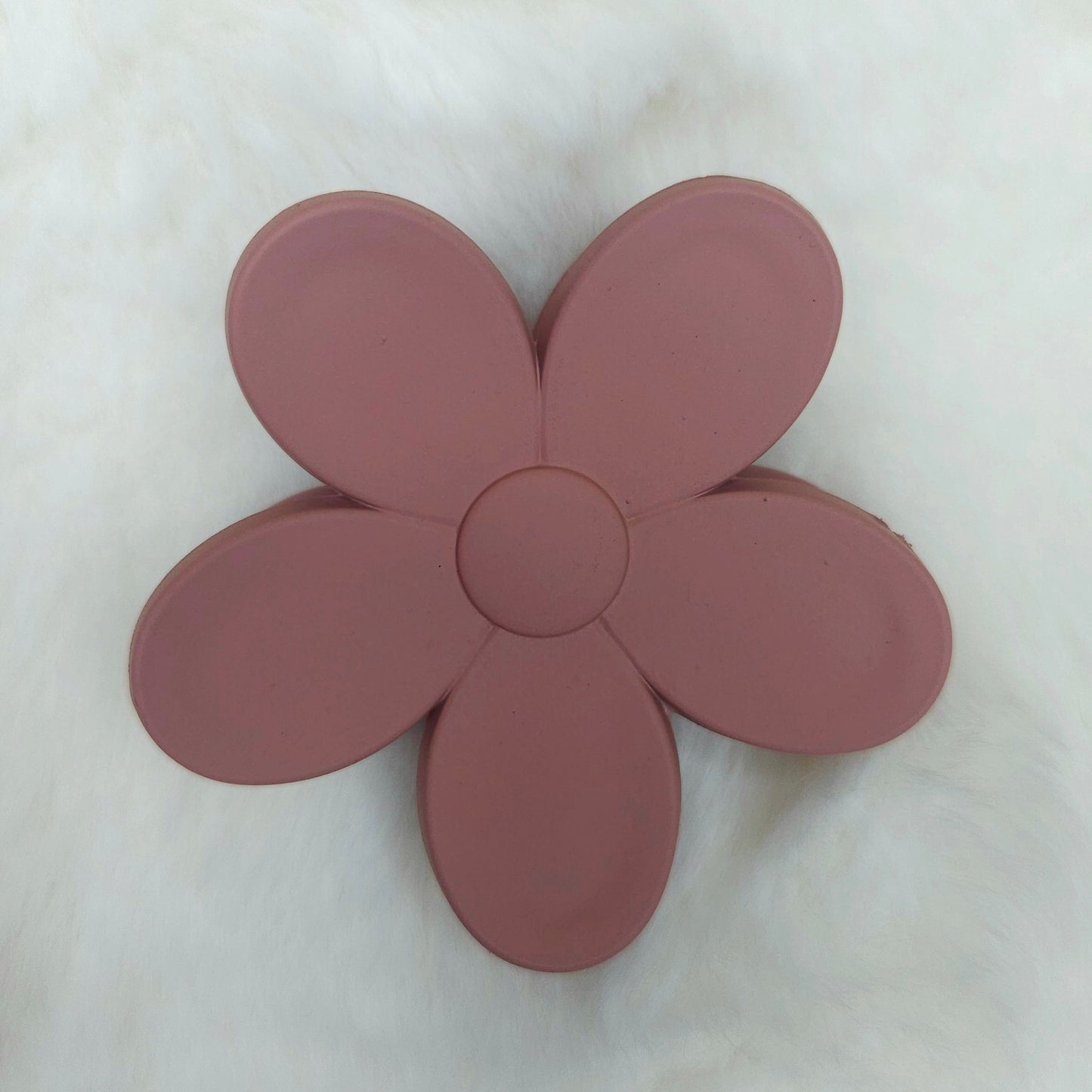 Pink flower-shaped hair claw on a white background