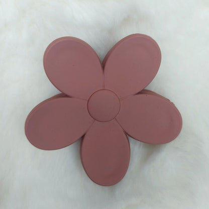 Pink flower-shaped hair claw on a white background