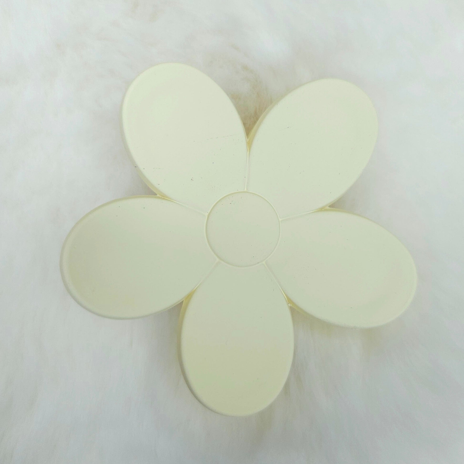Flower-shaped hair claw clip on a white background