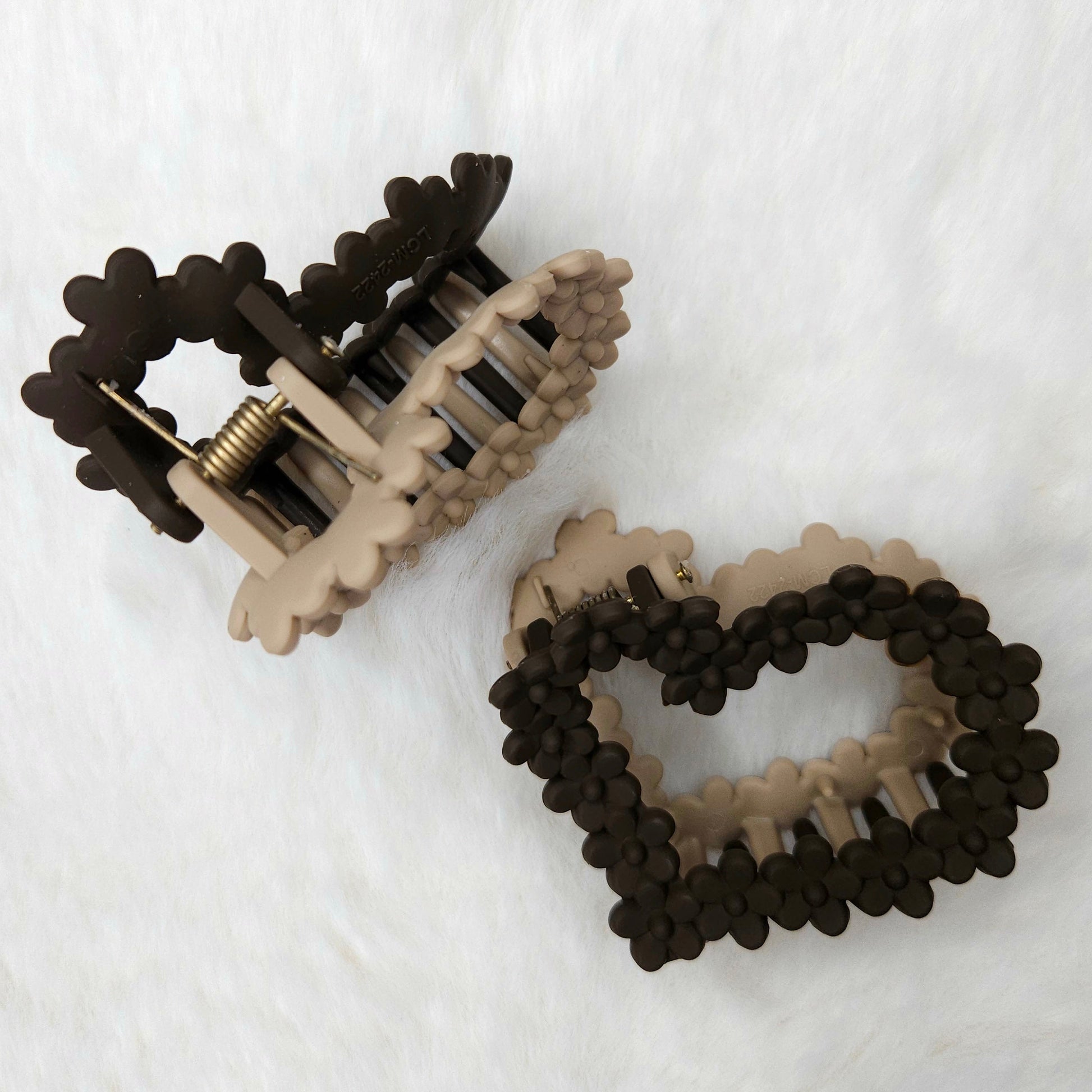 Heart-shaped hair claw clips on a white background