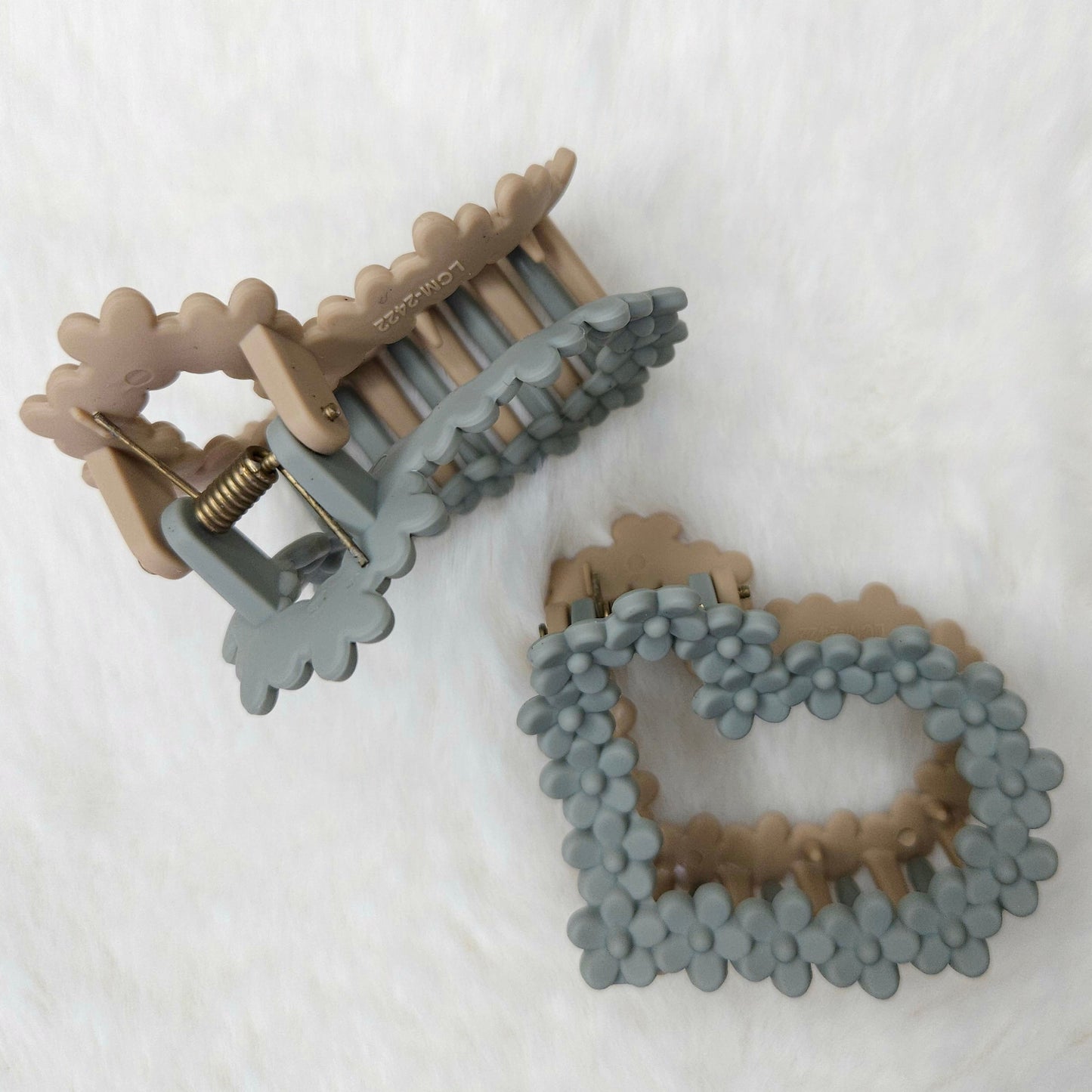 Two decorative hair claw clips on a white background