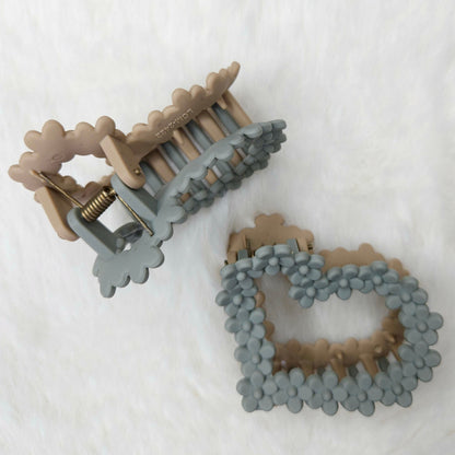 Two decorative hair claw clips on a white background