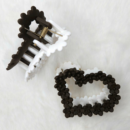 Black and white hair clip and beaded hair claw on a white background