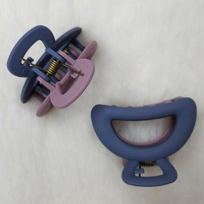 Two purple and blue shared hair clips on a white background
