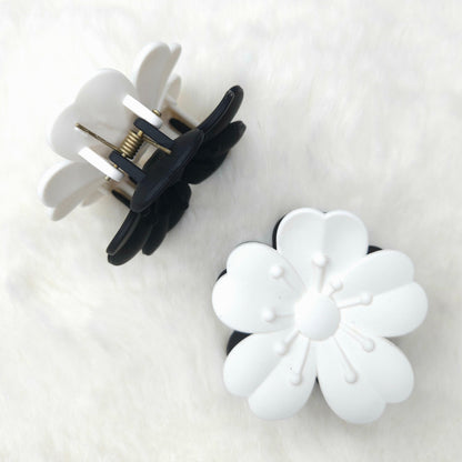 Flower-shaped hair claw clips on a white background