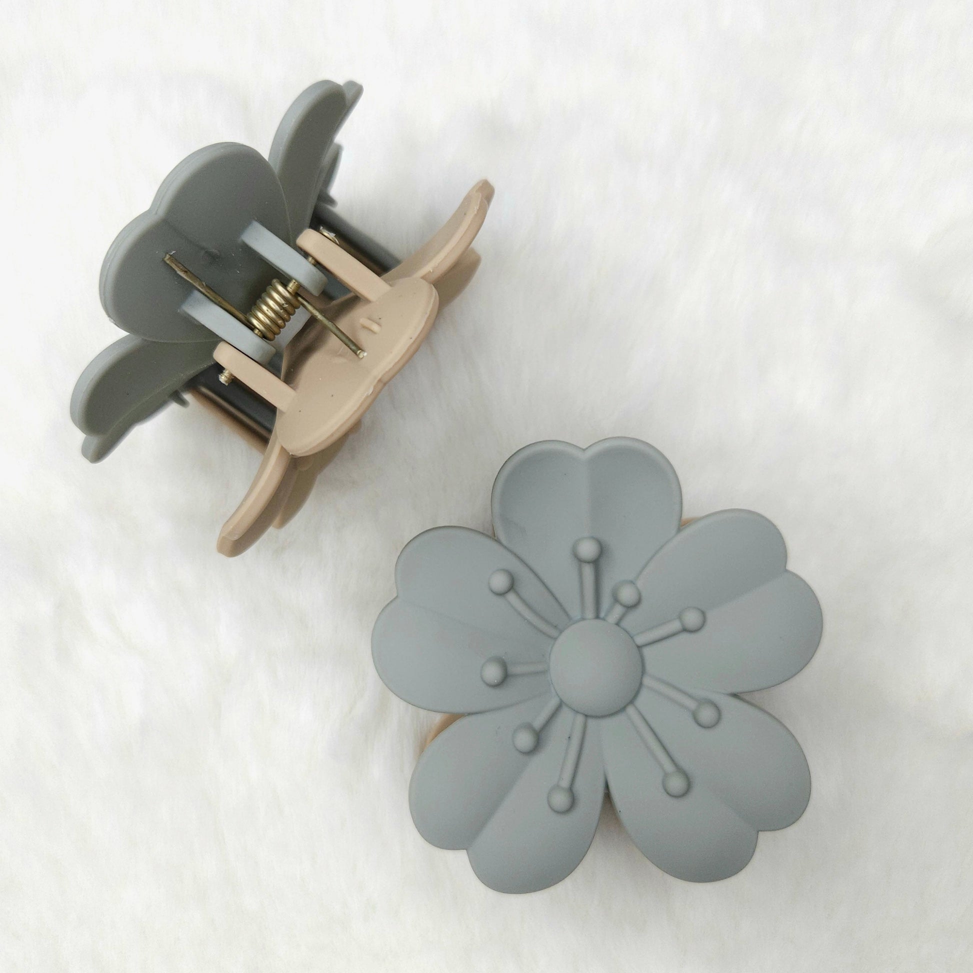 Gray floral hair clip on a white background