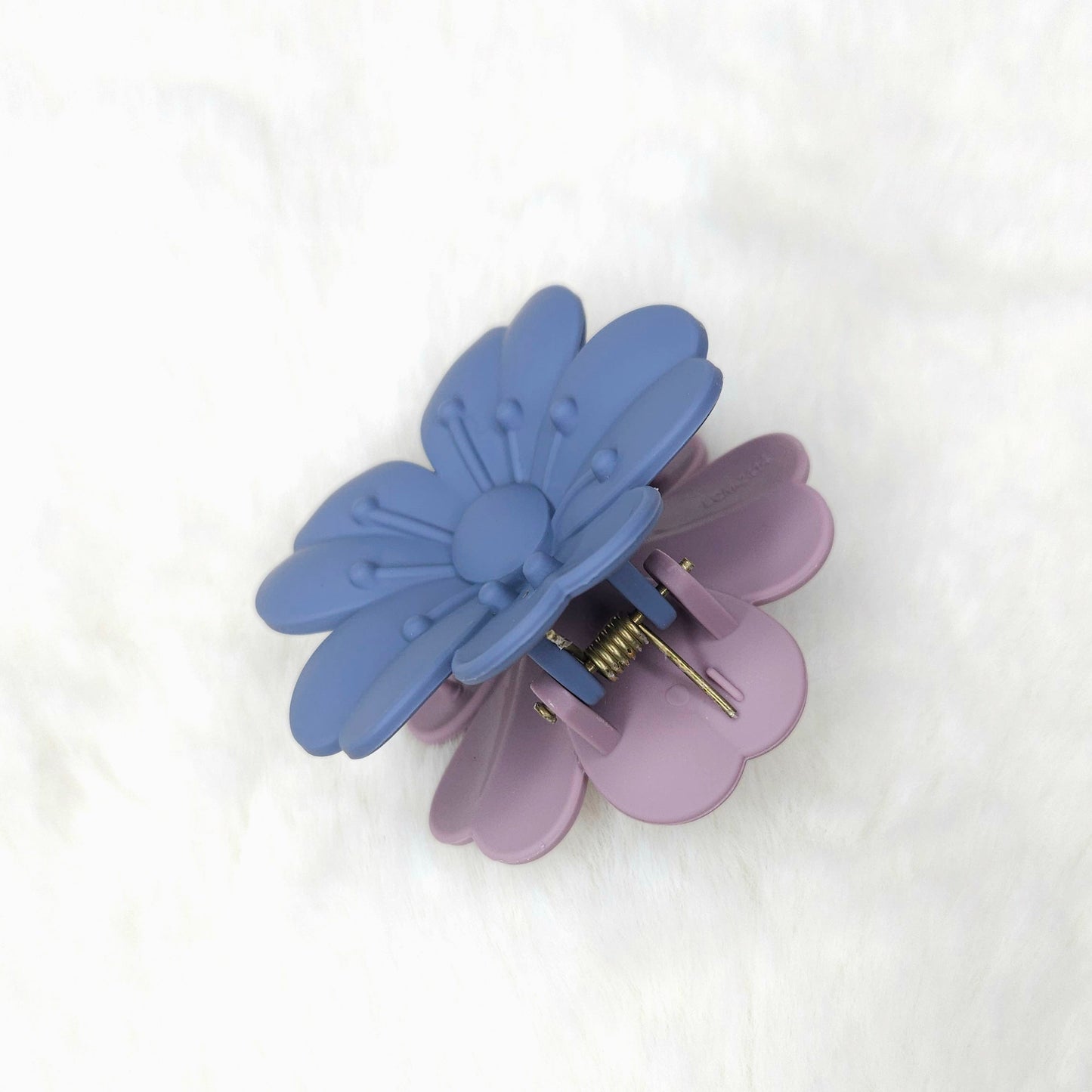 Blue and purple butterfly-shaped hair clip on a white background