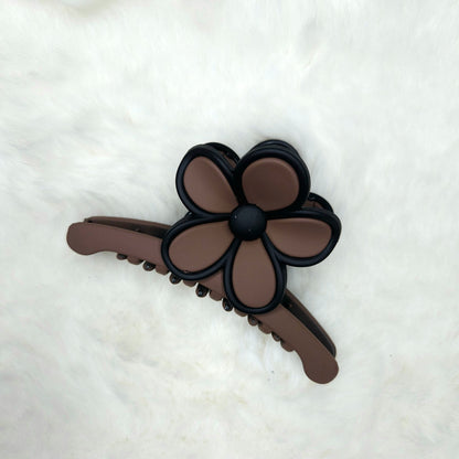 Brown hair claw clip with flower design on a white background