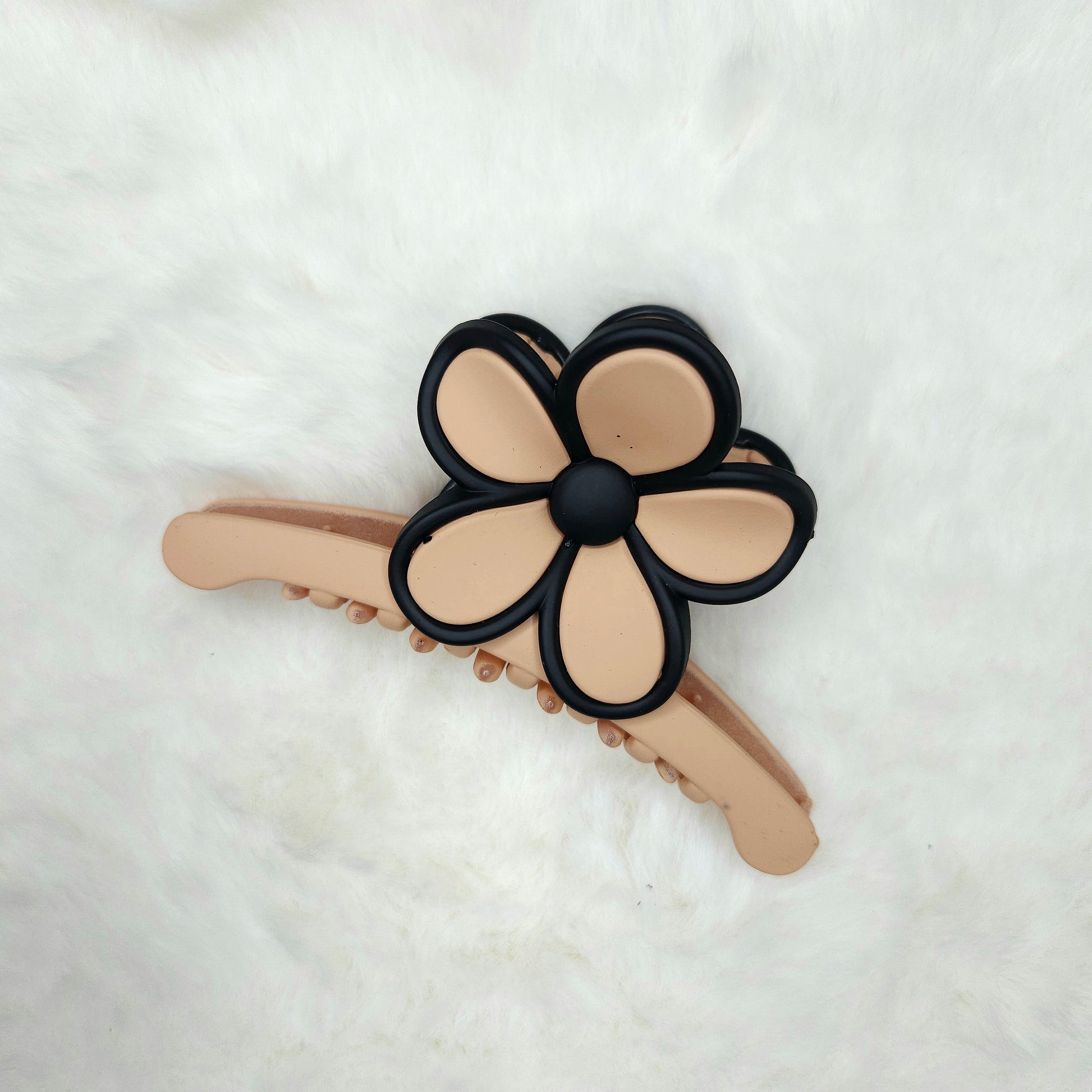 Cream color Floral-shaped hair claw clip on a white background