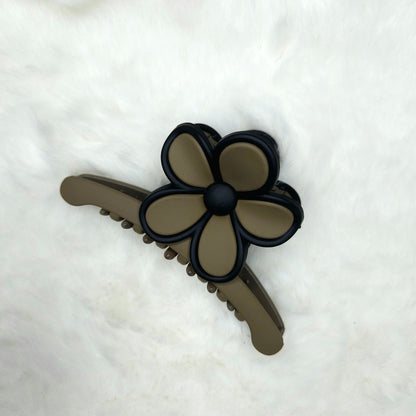 Green color Hair claw clip with flower design on a white background