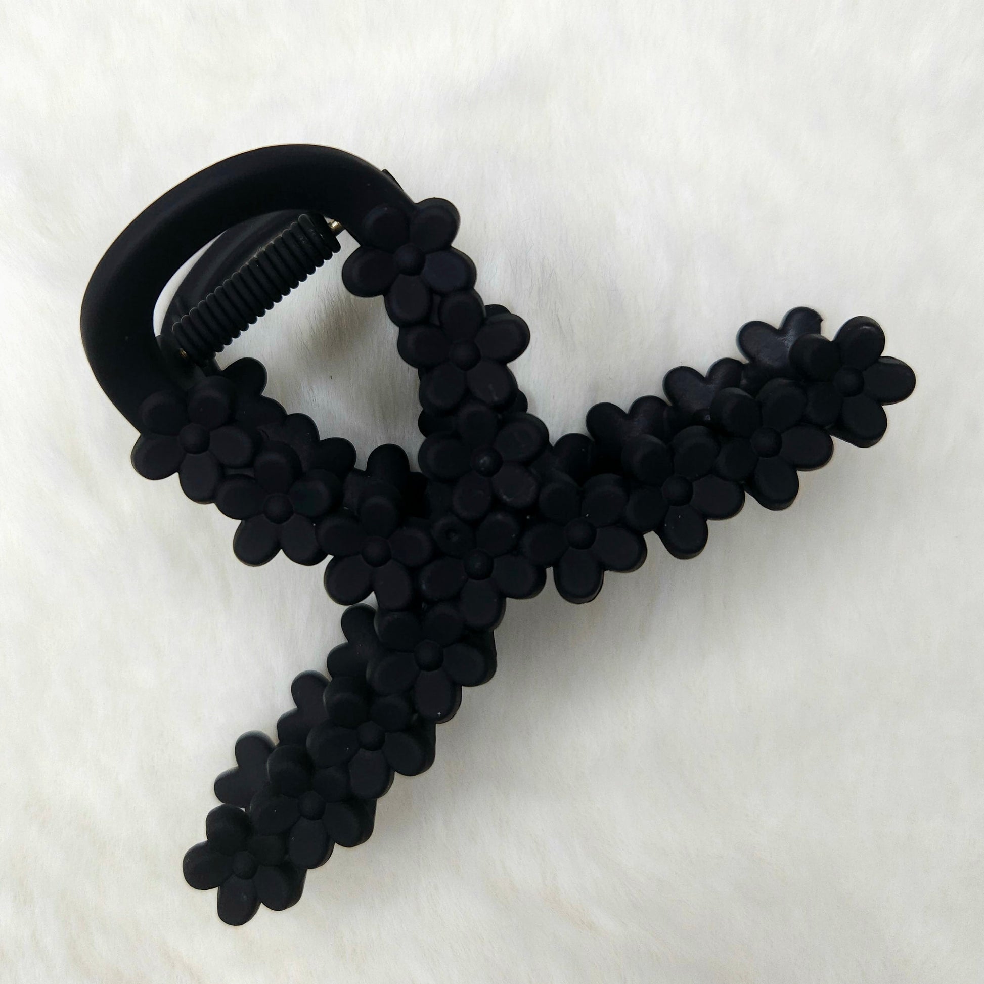 Loop shaped black hair claw clip on a white background