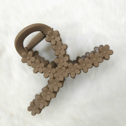 Light brown floral-patterned hair claw clip on a white background