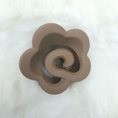 Brown ceramic flower-shaped hair claw on a white background