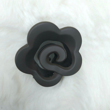 Black rose-shaped hair claw on a white background