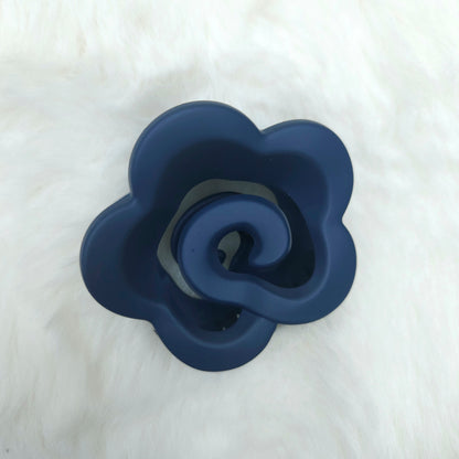 Blue silicone flower-shaped hair claw on a white background