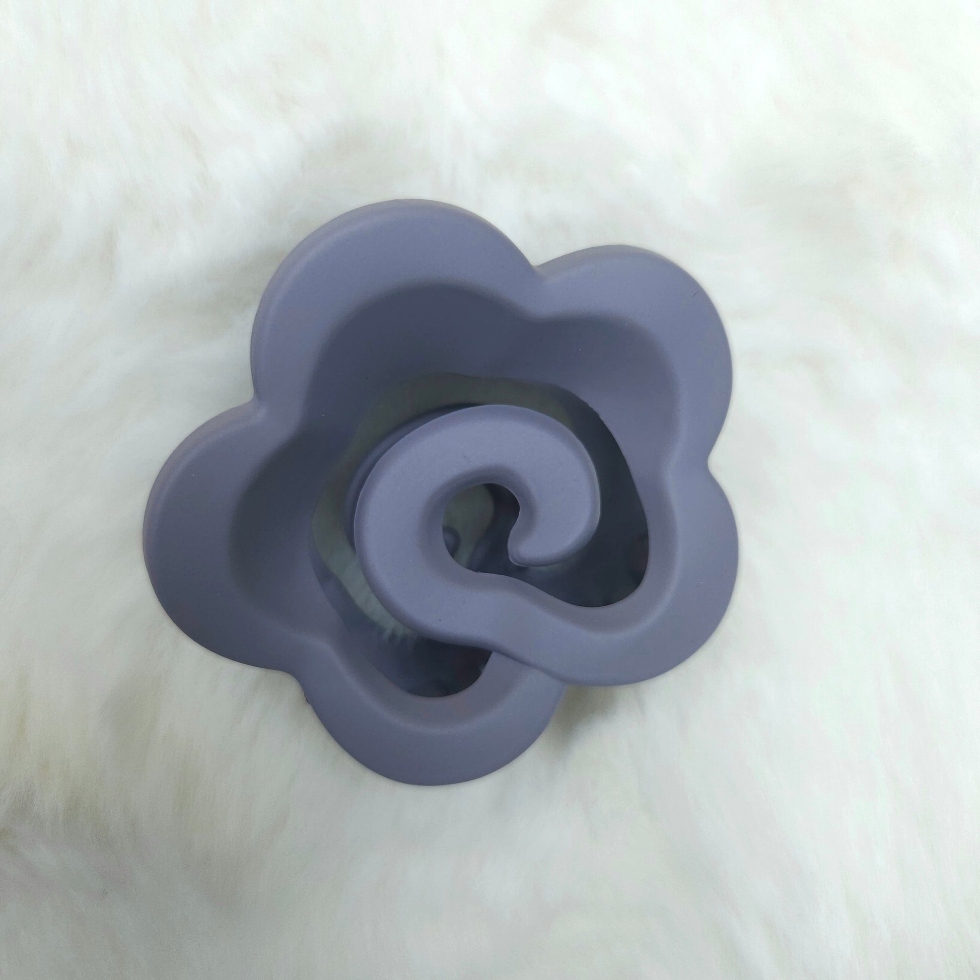 Purple flower-shaped hair claw on a white background
