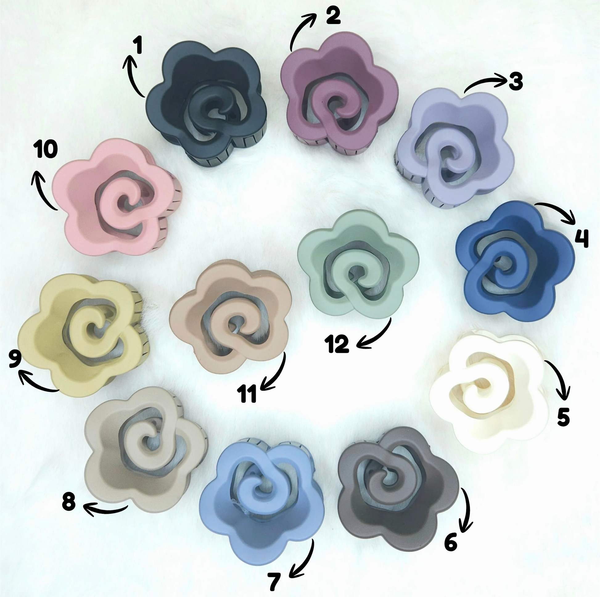 Colorful hair claws arranged in a circular pattern with labeled colors on a white background