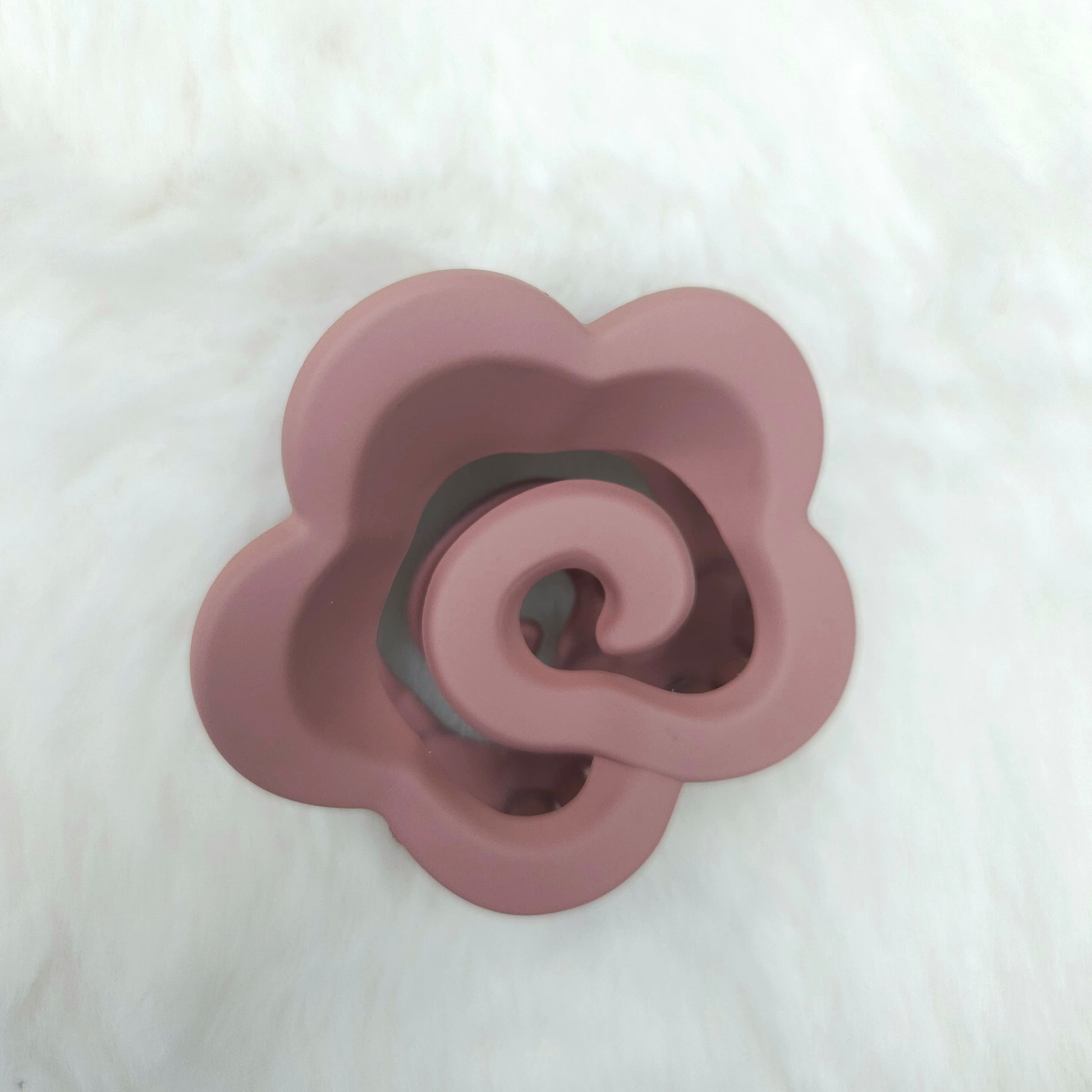 Pink flower-shaped hair claw on a white background