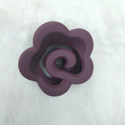Purple flower-shaped hair claw on a white background