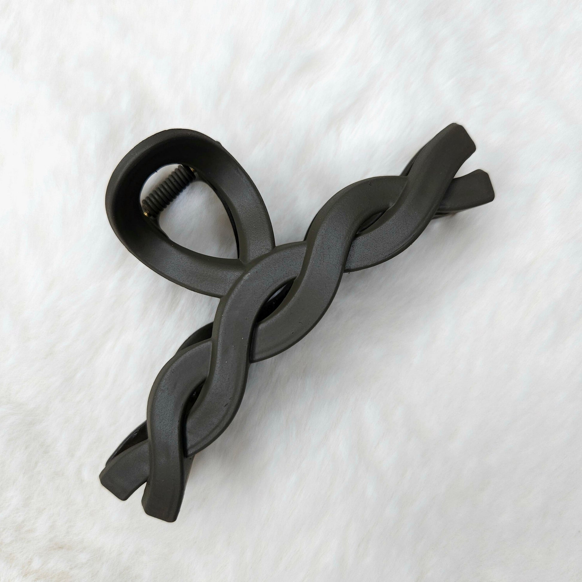 Brown color twisted design hair claw clips placed on a white background