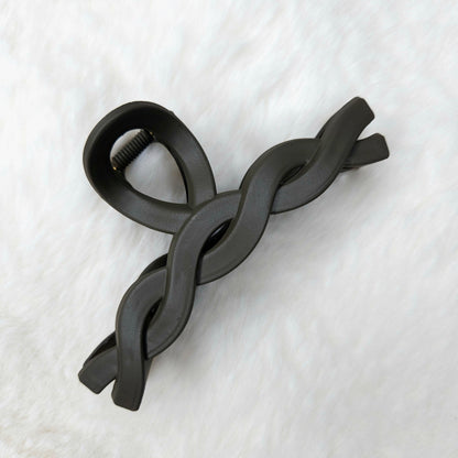 Brown color twisted design hair claw clips placed on a white background