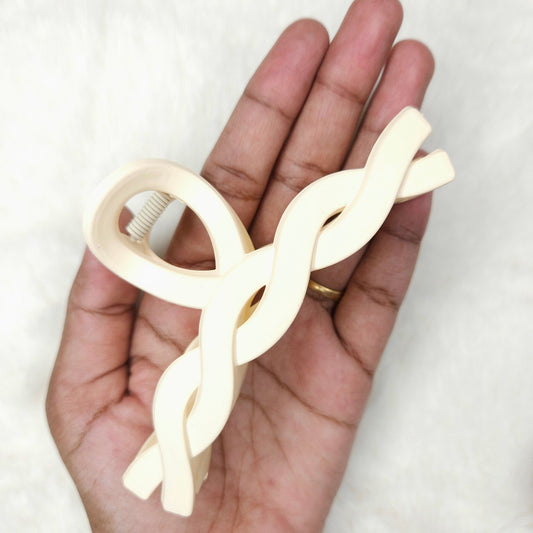Hand holding a white plastic tool against a white background