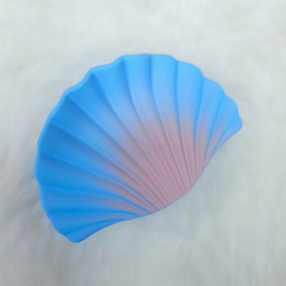 Blue shell-shaped hair claw on a white background