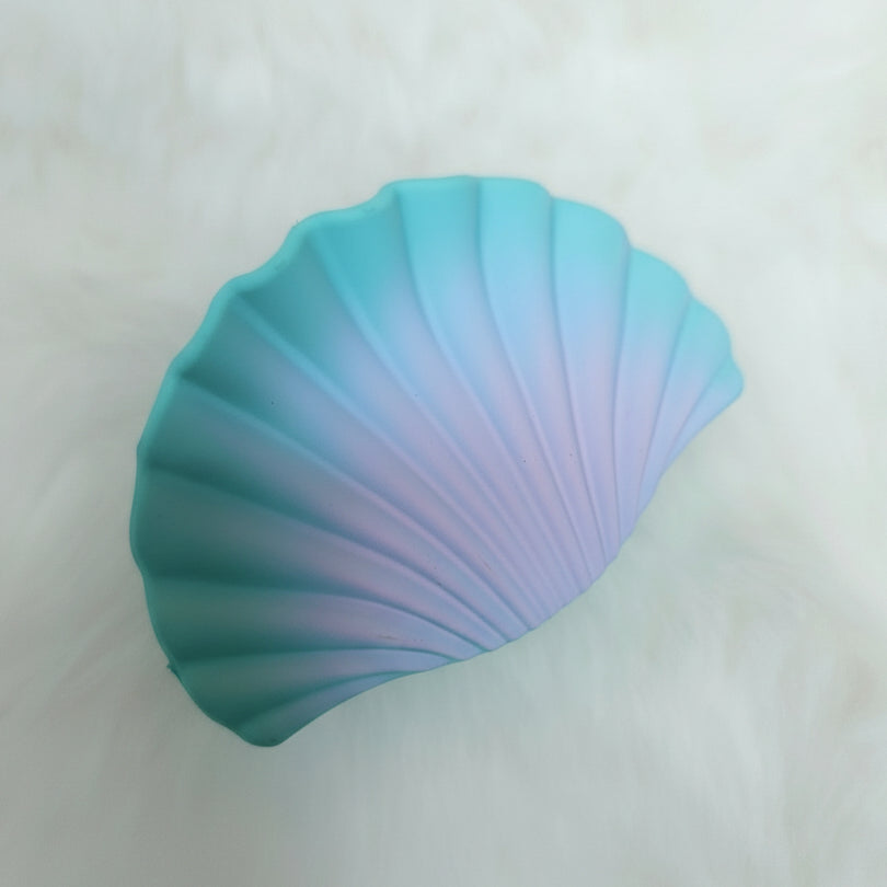 Gradient blue and purple shell-shaped hair claw on a white background