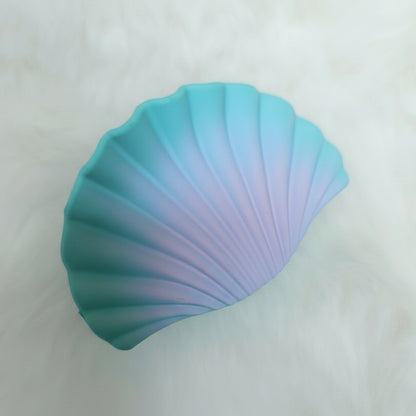 Gradient blue and purple shell-shaped hair claw on a white background