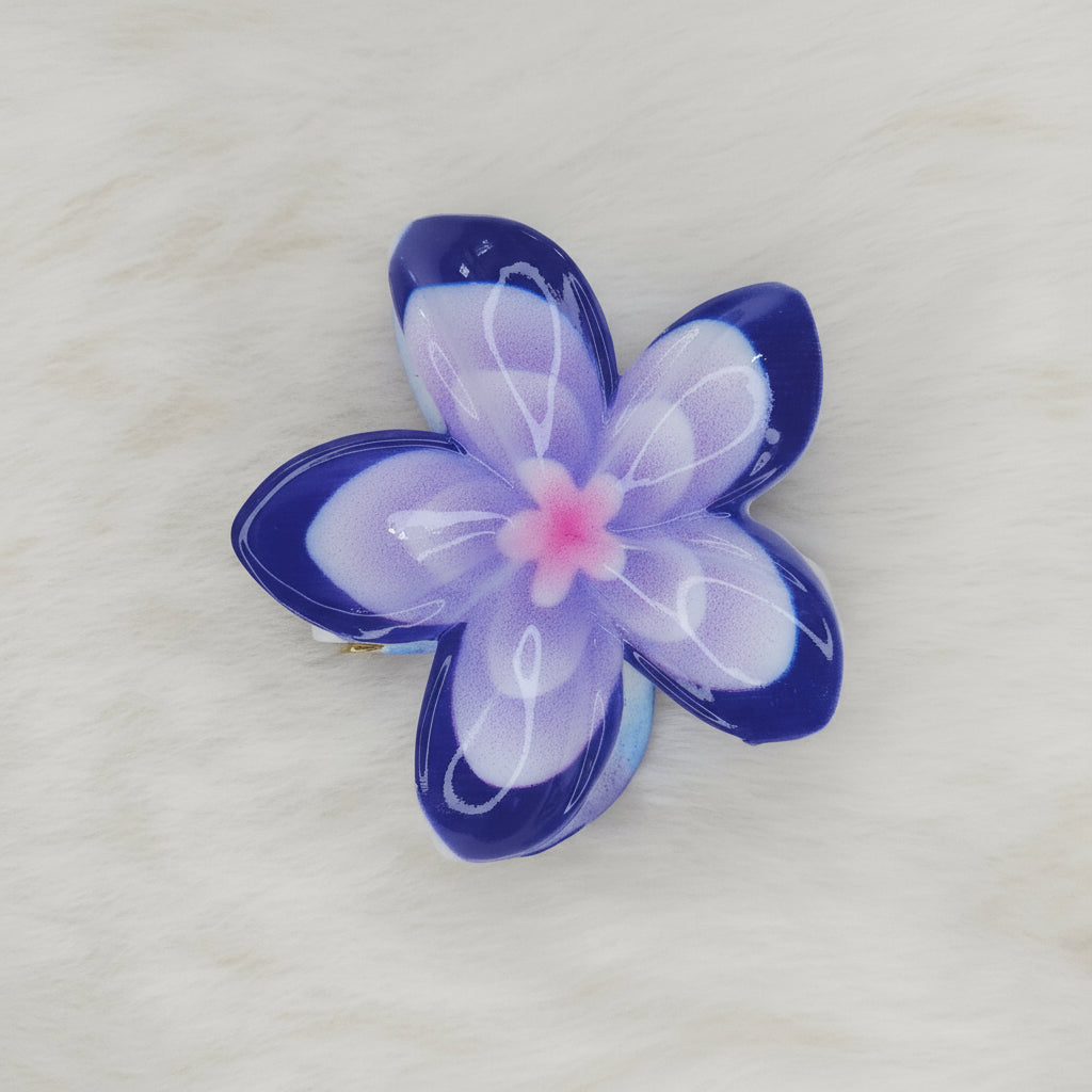 A blue and white translucent plastic flower-shaped hair clip with a light blue center, seen from above, with the clip mechanism slightly visible underneath.