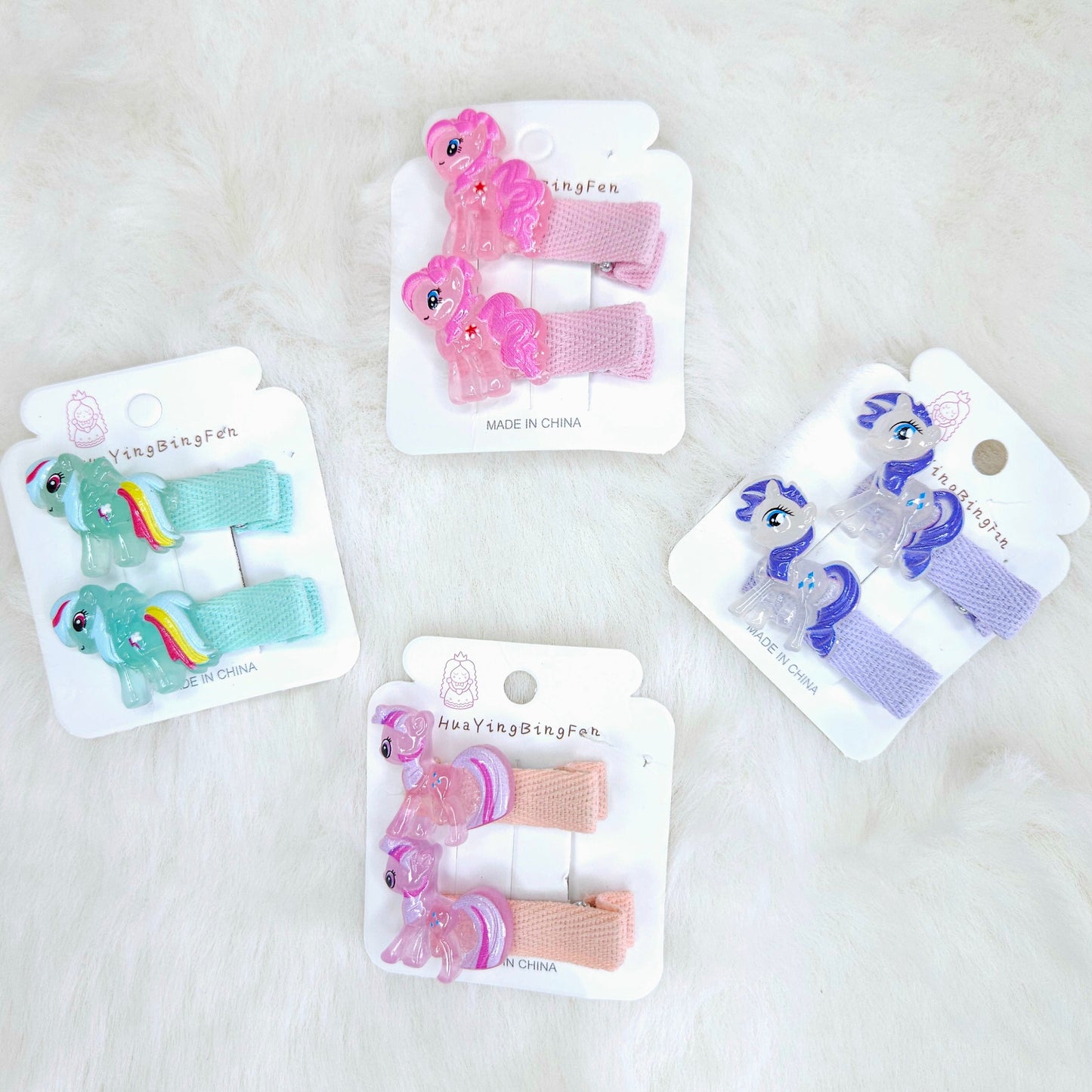 Set of colorful hair clips on their packaging with a white background