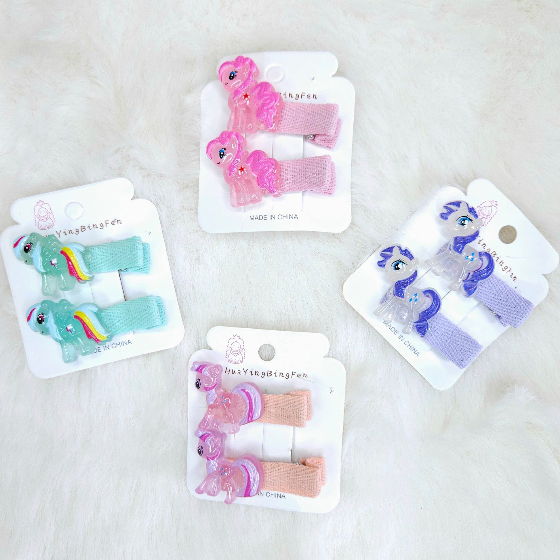 Set of colorful hair clips on their packaging with a white background