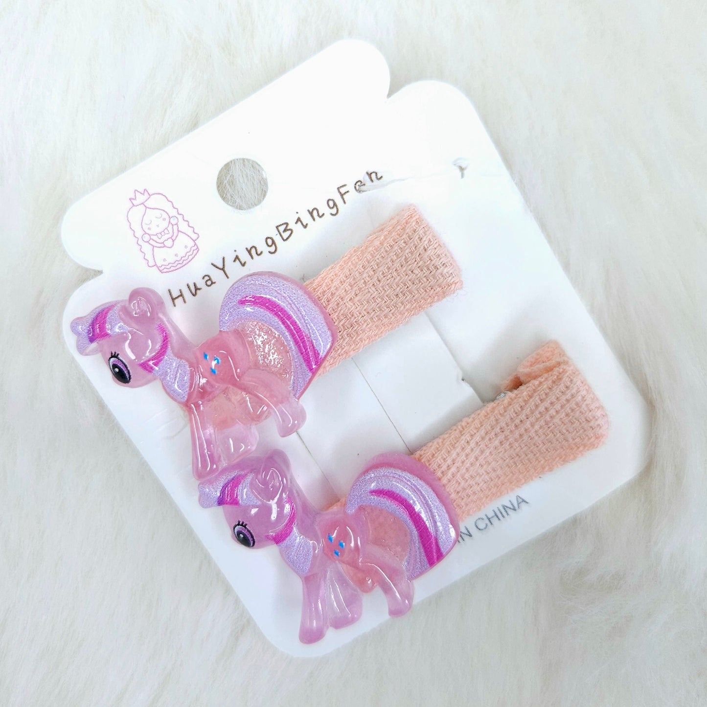 Set of pink hair accessories on a white card with 'Huayin Bingfen' branding, on a light wooden surface.