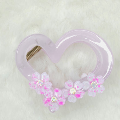 Heart-shaped hair clip with floral decorations on a white background