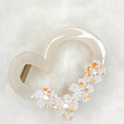 Floral decorative hair claw clip on a white background