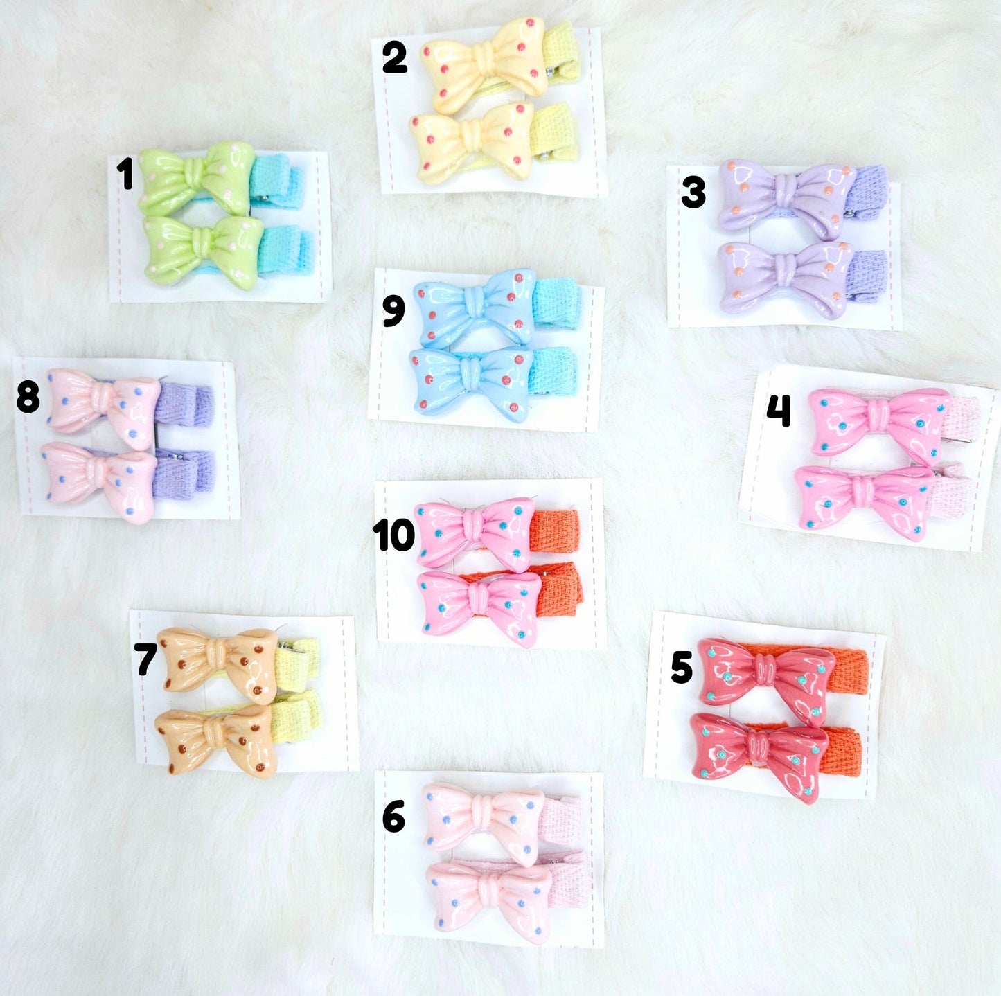Set of colorful hair bow clips on white cards with numbers