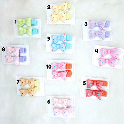 Set of colorful hair bow clips on white cards with numbers