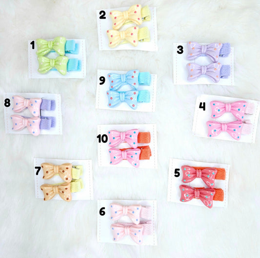 Set of colorful hair bow clips on white cards with numbers