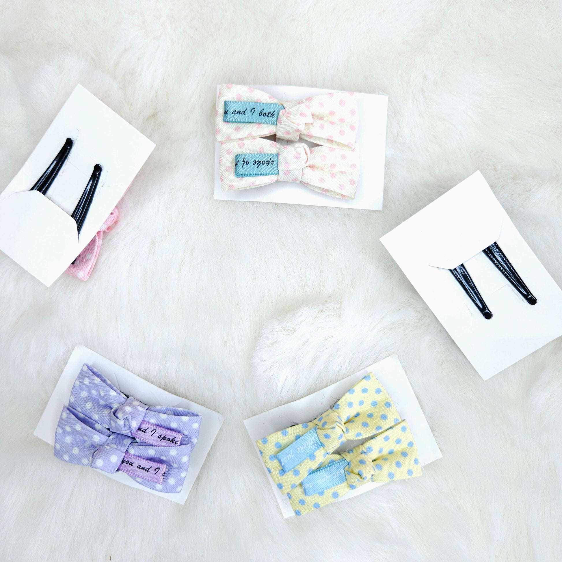 Collection of hair accessories including bows and clips on a white surface