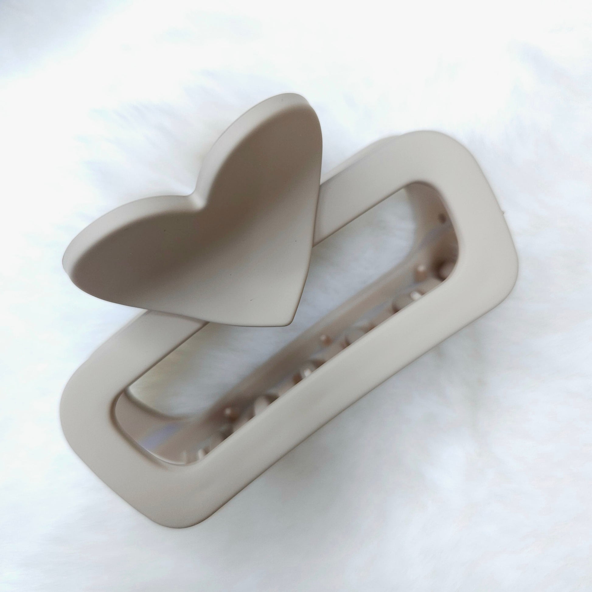 Beige hair clip on a white background