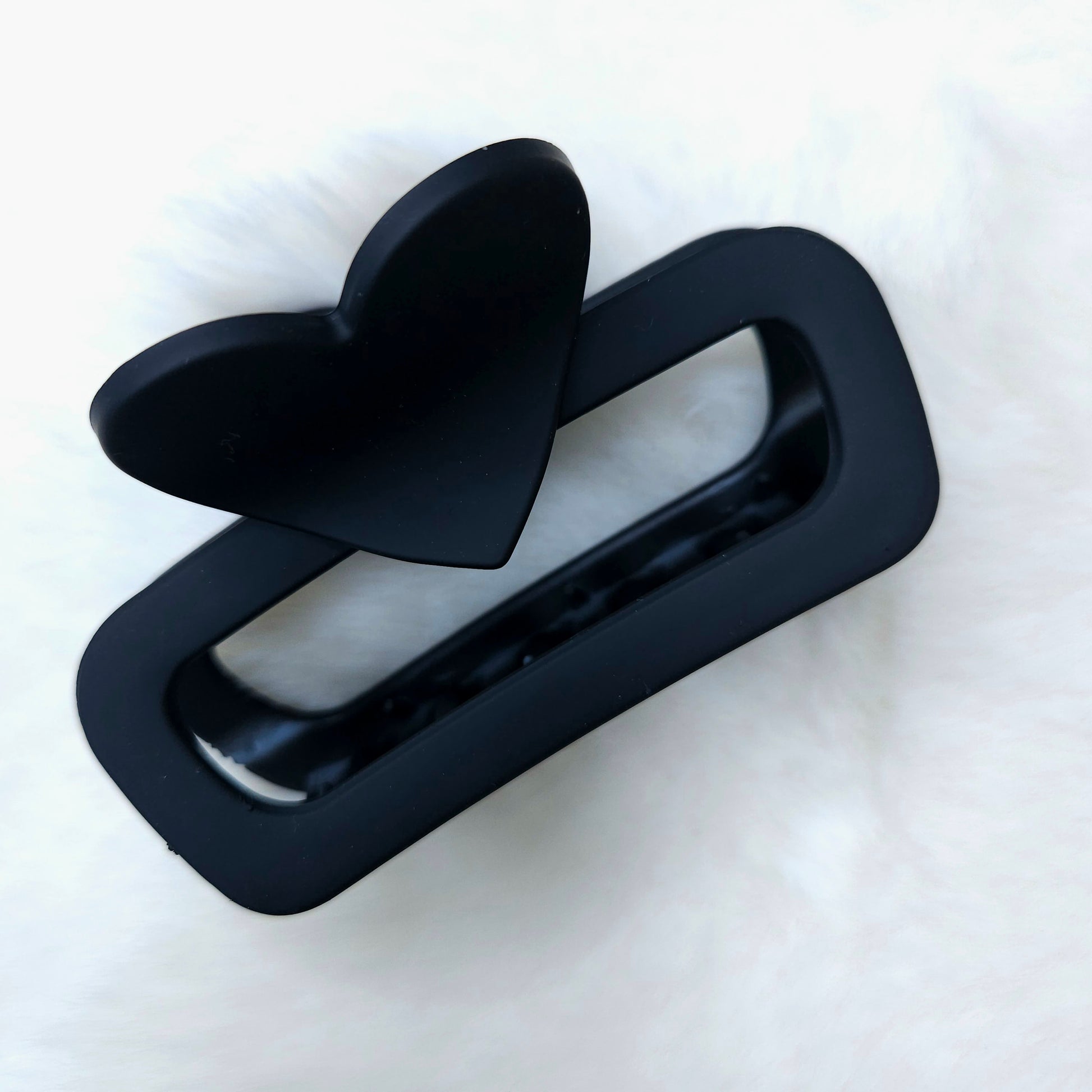 Black hair clip with a bow on a white background