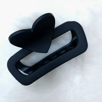 Black hair clip with a bow on a white background