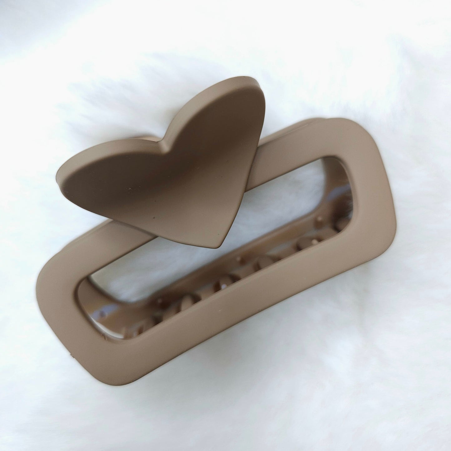 Beige hair clip on a white background