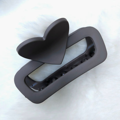 Black plastic component on a white background