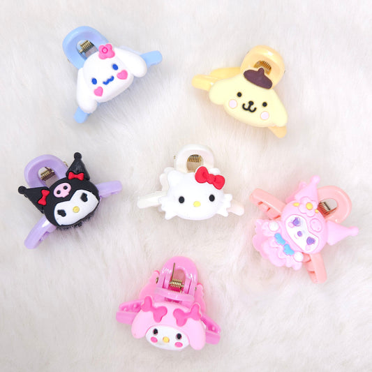 Set of colorful animal-themed hair clips on a light gray background