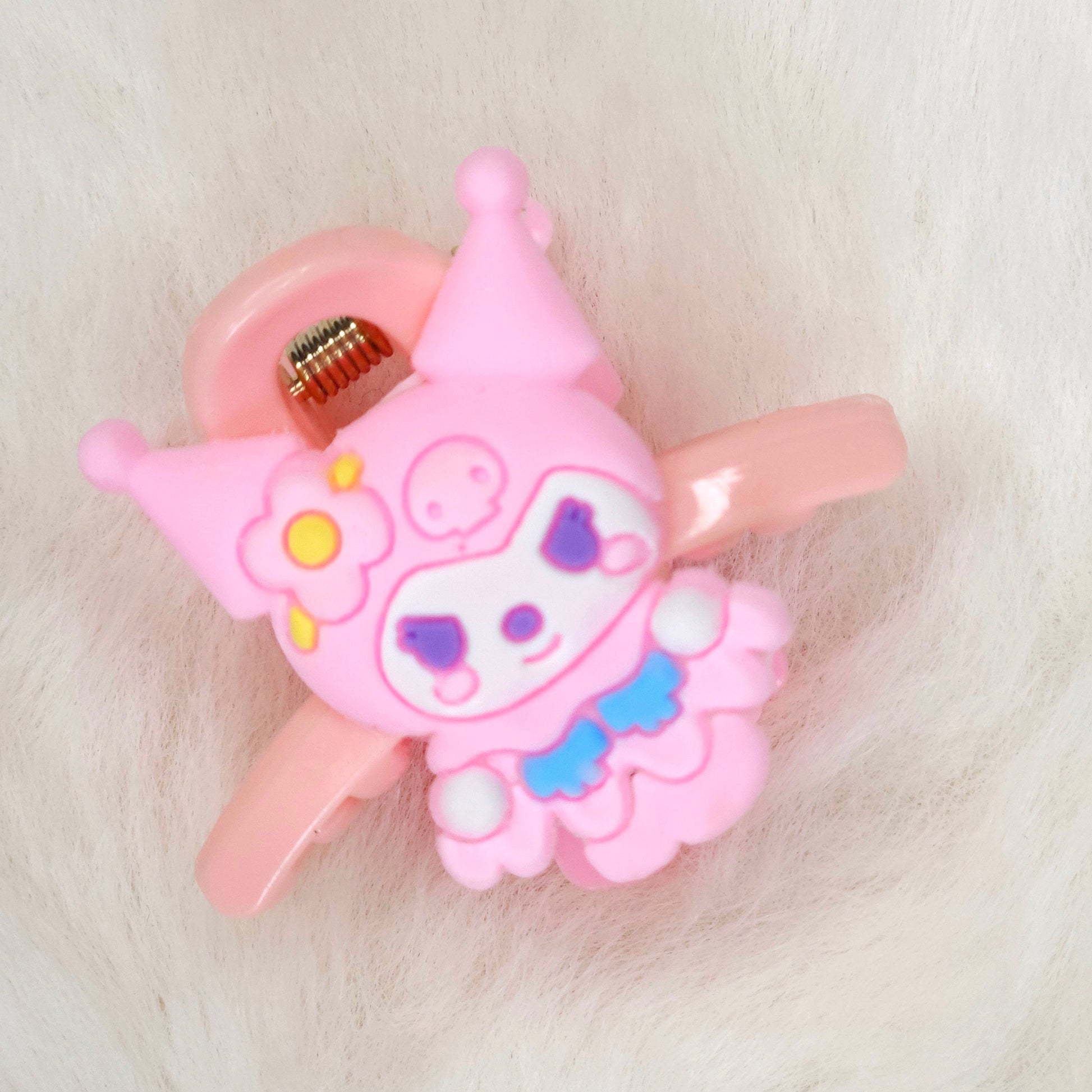 Pink cartoon character hair clip on a white background