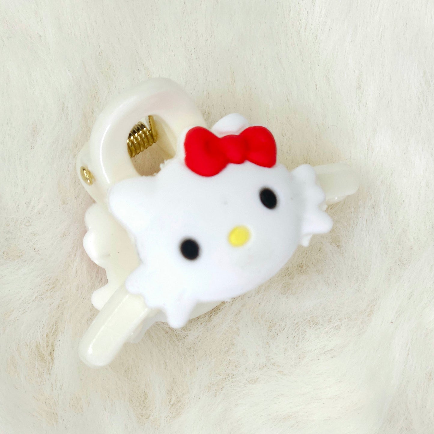 Hello Kitty-themed phone jack hair claw clip on a white background
