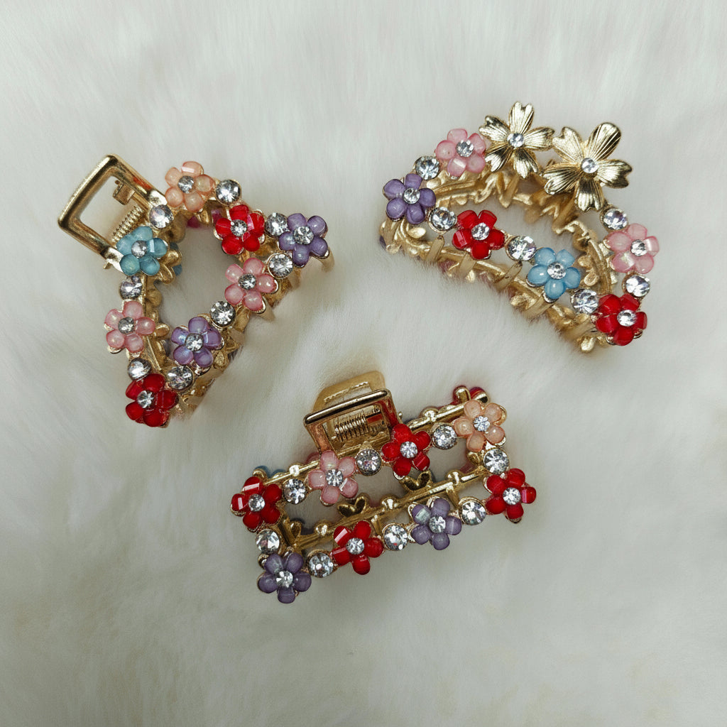 Decorative hair clips with floral designs on a light background