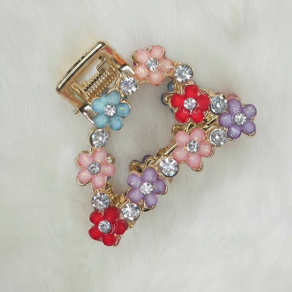 Decorative hair clip with colorful flowers and crystals on a white background